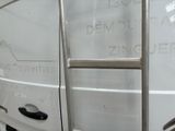 a white van with a ladder on the side of it