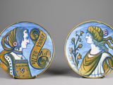 pair of painted plates depicting two women and a banner