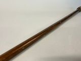 an old baseball bat sitting on top of a table next to a white wall