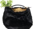 black fur purse with a plant in it on a white background