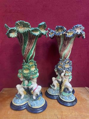 two vases that are sitting on a table