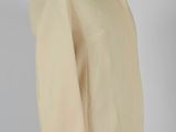 an image of a beige jacket on a mannequin stand