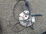 a machine that is sitting on the ground next to other tools