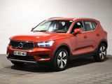 a red volvo suv parked in a garage with a checkered floor