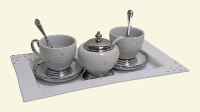 a tray with three cups and a saucer on it