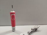a toothbrush and a charger on a white table