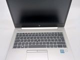 an open laptop computer sitting on top of a white table