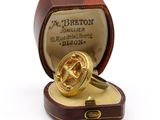 a ring in a box with a gold ring inside of it