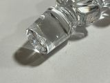 a clear glass bottle with a glass stopper on it