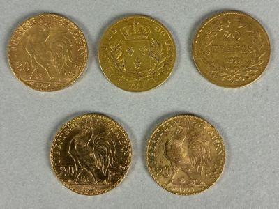 four different types of gold coins on a white surface