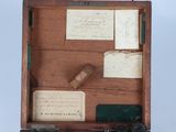 an old wooden box with papers and papers in it