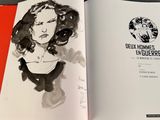an open book with a drawing of a woman in a black dress