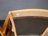 a wooden chair with a black seat and a black seat