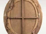 an image of a round wooden window with a cross on it