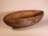 a wooden bowl sitting on a table with a white background
