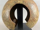 an image of a sculpture of a circular object on a black base