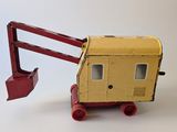 a yellow and red toy truck with a crane on top of it