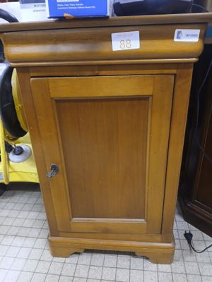 a wooden cabinet with a blue sign on top of it