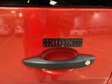 a close up of a car door handle with a sticker on it