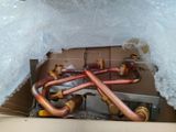 a box that has a bunch of copper pipes inside of it