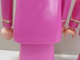 two toy figures of a woman and a man in pink