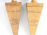 pair of antique wooden pegons with labels on them on a white surface