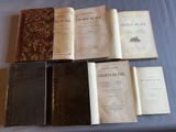 several old books sitting on top of a table next to each other
