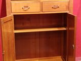a wooden cabinet with two sinks on top of it