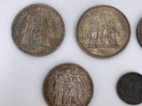 six different types of coins are shown on a white surface