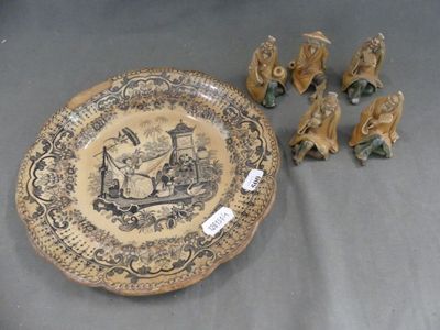several figurines of elephants and a plate with a picture on it