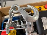 a close up of a clamp and wire rope in a box
