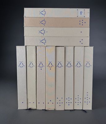 several books stacked on top of each other on a table