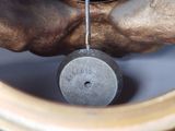 a close up of a clock with a pendulum on it