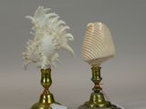 pair of antique brass candlesticks with shells on top of them