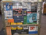 a metal cart with many items in it in a warehouse