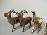 three bronze deer figurines sitting next to each other