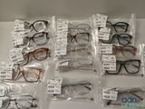 many pairs of glasses on the table with price tags on them