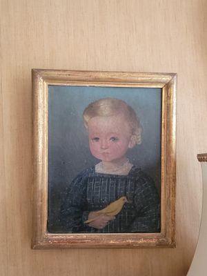 a picture of a little boy with a bird on a table