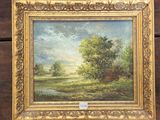 un tableau représentant un paysage avec des arbres et de l'eau, dans un cadre doré
