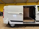 a white van with its doors open in a garage