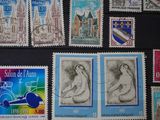 several stamps of different countries are displayed on a black surface