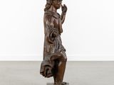 a bronze statue of a man with his hand on his chin