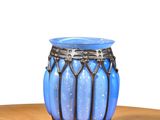 a blue vase sitting on top of a wooden table