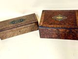 two small wooden boxes sitting on top of each other on a table
