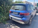 the rear end of a blue mercedes suv parked on the side of the road