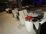 tables and chairs are lined up in a row in a restaurant
