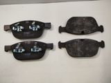 three pairs of brake pads sitting on top of a white surface