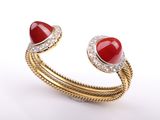 a close up of a ring with a red stone on it