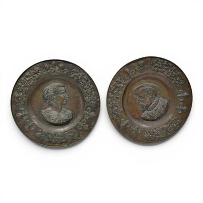 pair of bronze medallions of a man and a woman