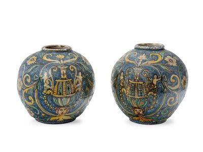 pair of blue and yellow vases with designs on them on a white background